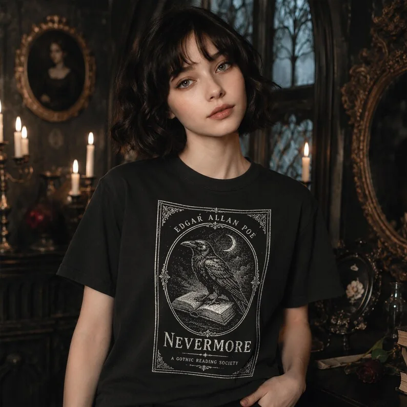 Close-up of black Comfort Colors Nevermore gothic literary t-shirt featuring a woodcut raven illustration on a dark academia model