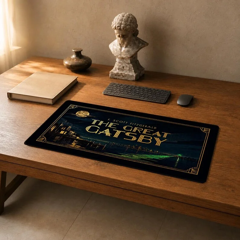 F. Scott Fitzgerald’s The Great Gatsby desk mat featuring the novel’s title as the focus within a symmetrical black-and-gold Art Deco design.