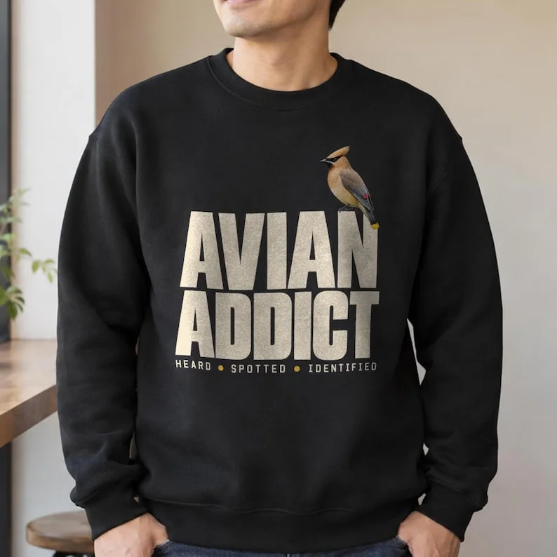 Black Avian Addict birdwatching sweatshirt on man, featuring cedar waxwing and Heard Spotted Identified design.